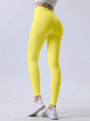 Women’s high-waisted yoga leggings in bright yellow; breathable fitness pants for running and cycling