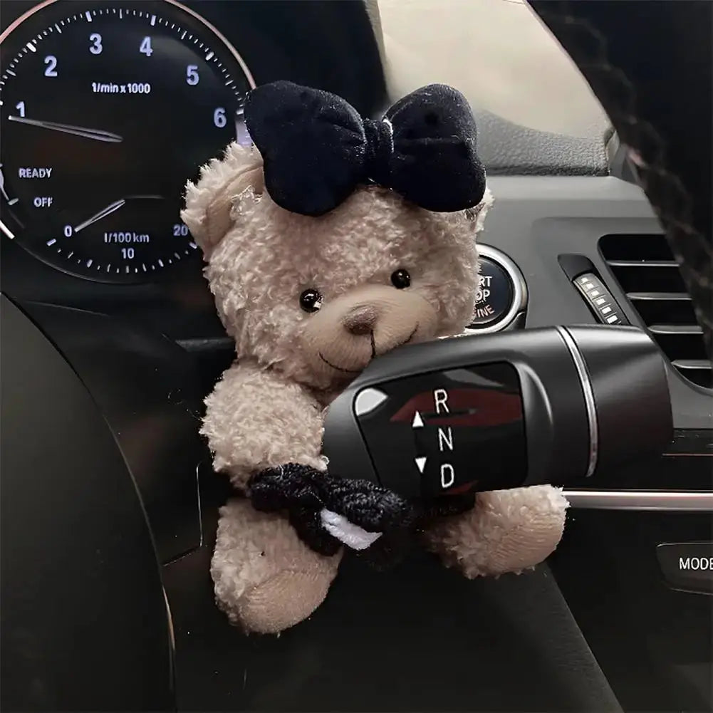 Pilot Bear plush car gear shift decoration with navy bow and beige fur.