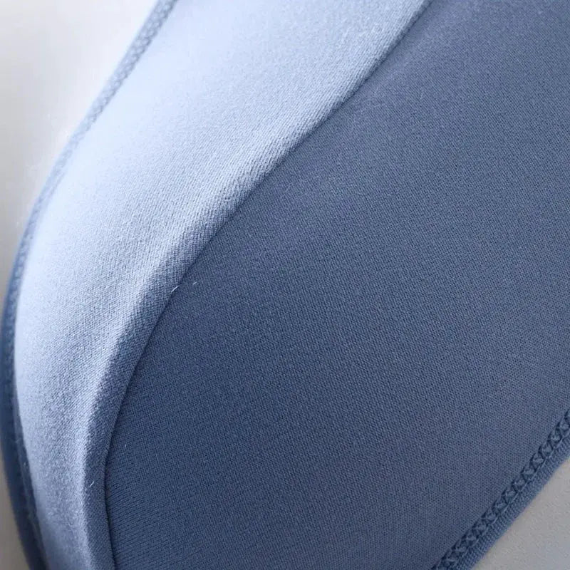 Men's briefs fabric close-up in blue with light and dark panels and visible stitching.