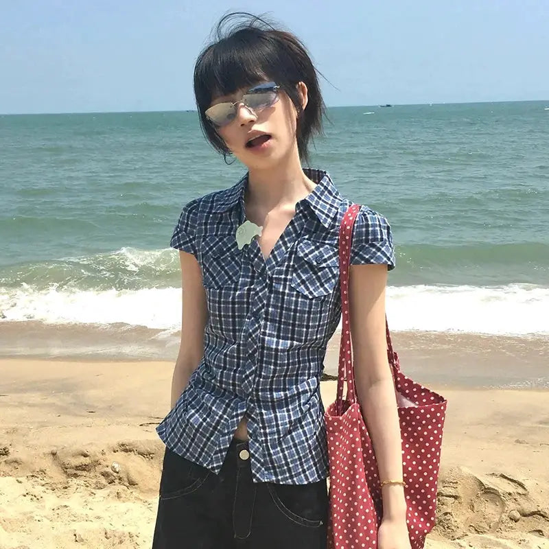 Plaid shirt, blue check, short-sleeve V-neck, worn by a model on the beach.