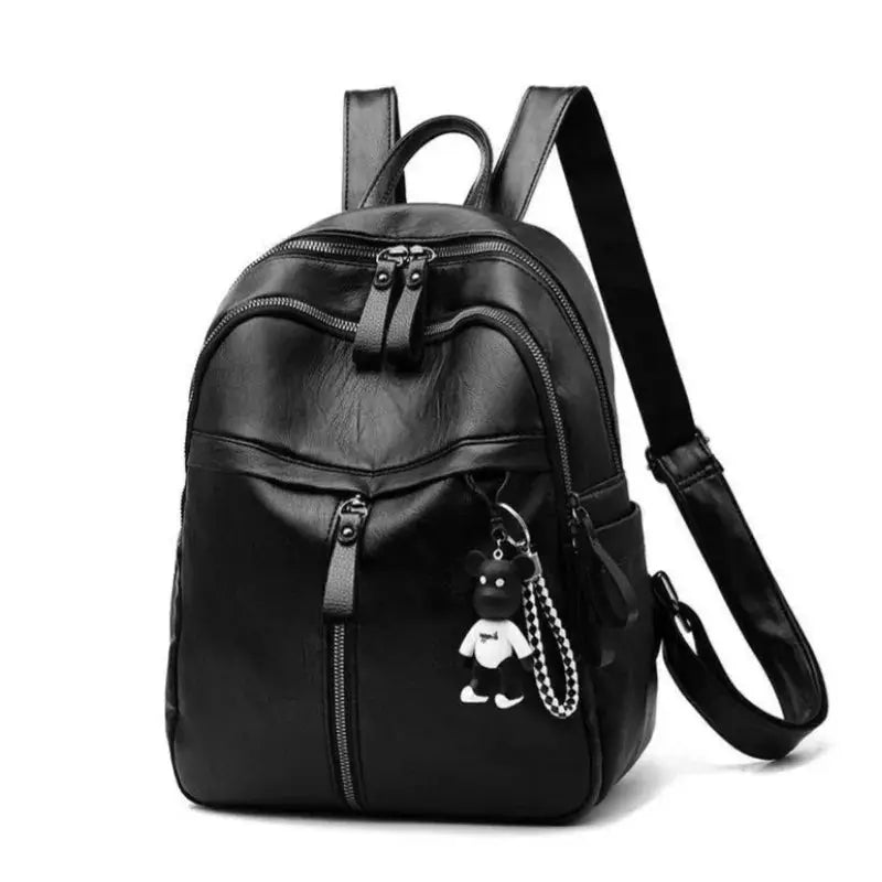 Bear backpack by Simples Market in black faux leather with top handle, dual zippers, and bear keychain.