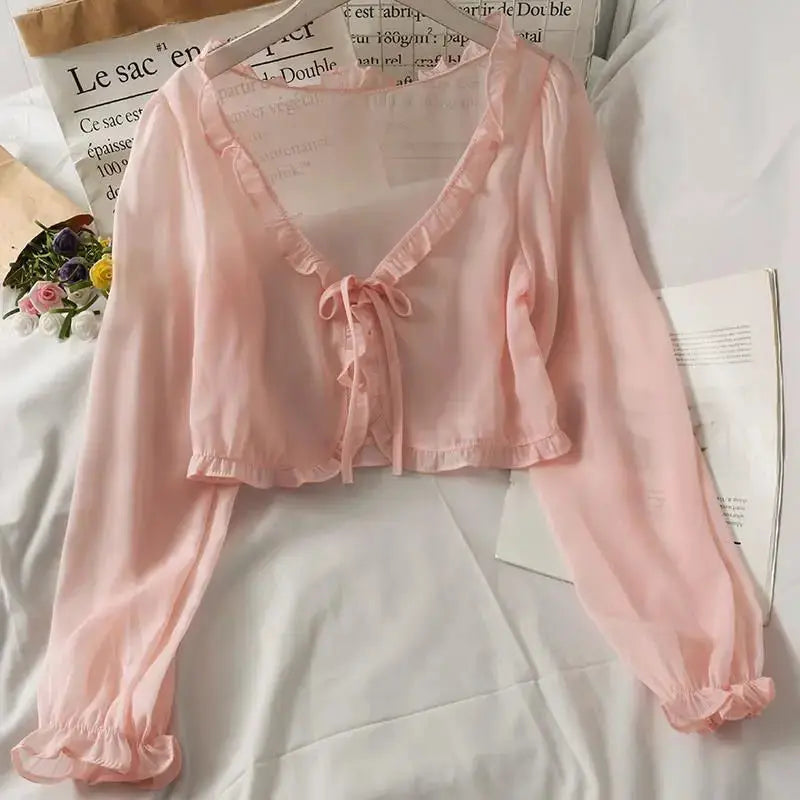 Pink long-sleeve sheer blouse with ruffle trim and front bow tie, cropped cardigan-style top