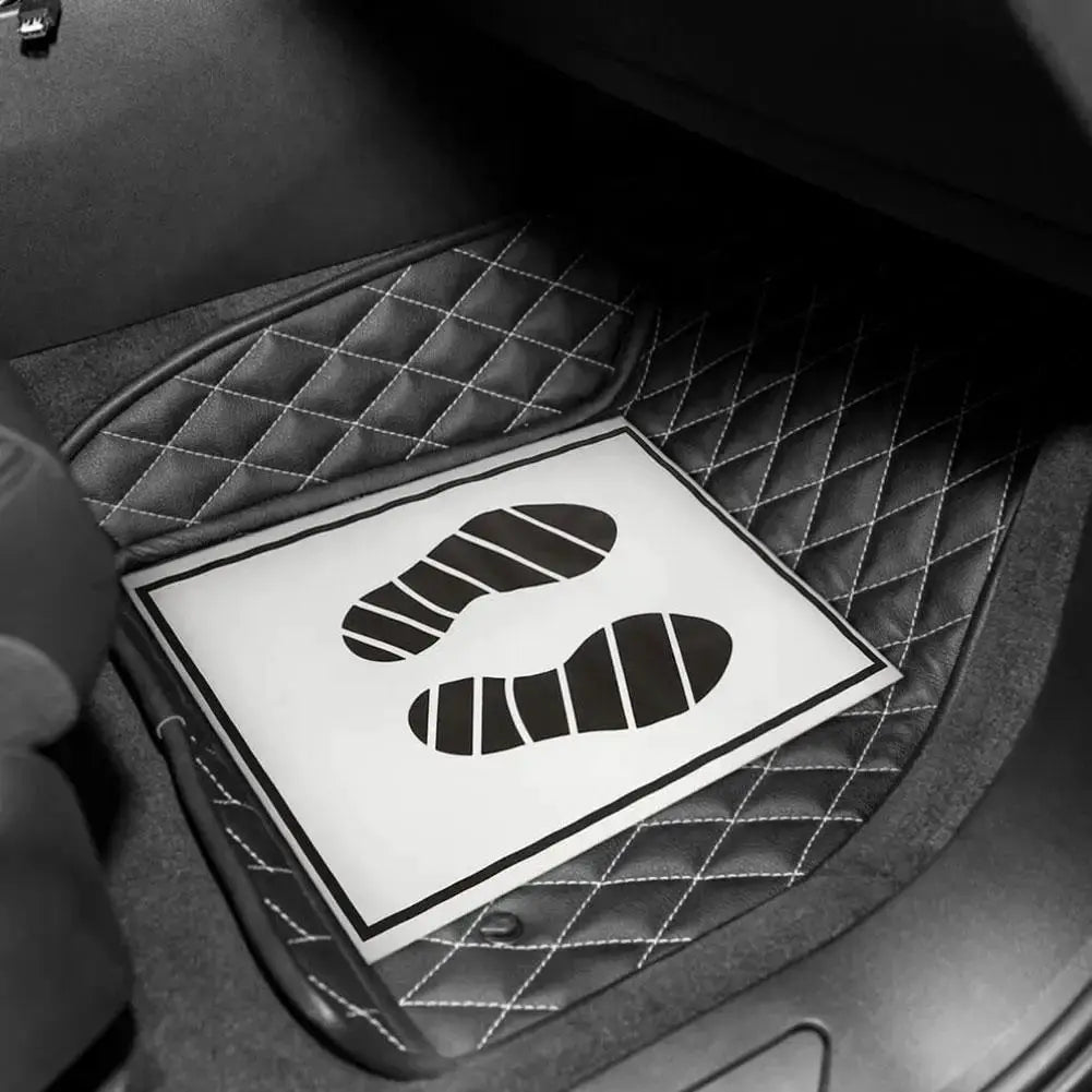 Disposable car floor mats; waterproof anti-slip white sheet with footprint icon on a quilted car floor