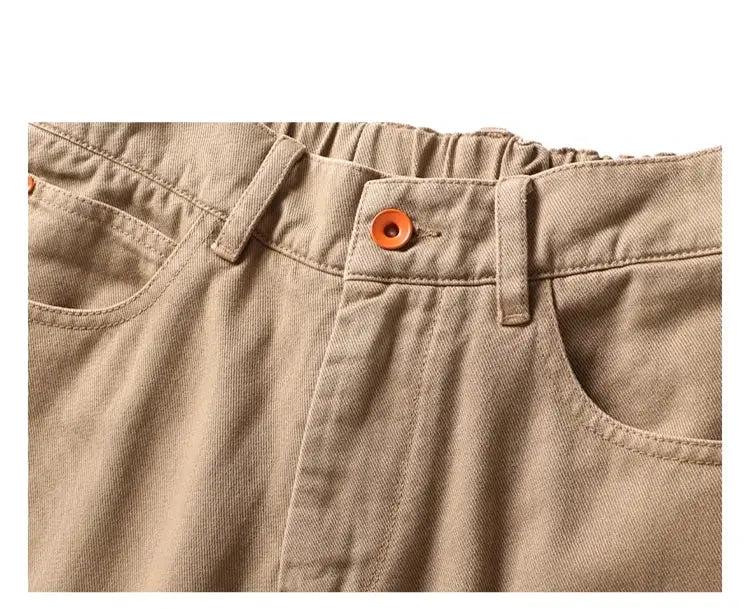 Men's beige cargo pants with belt loops, front pockets and orange button.