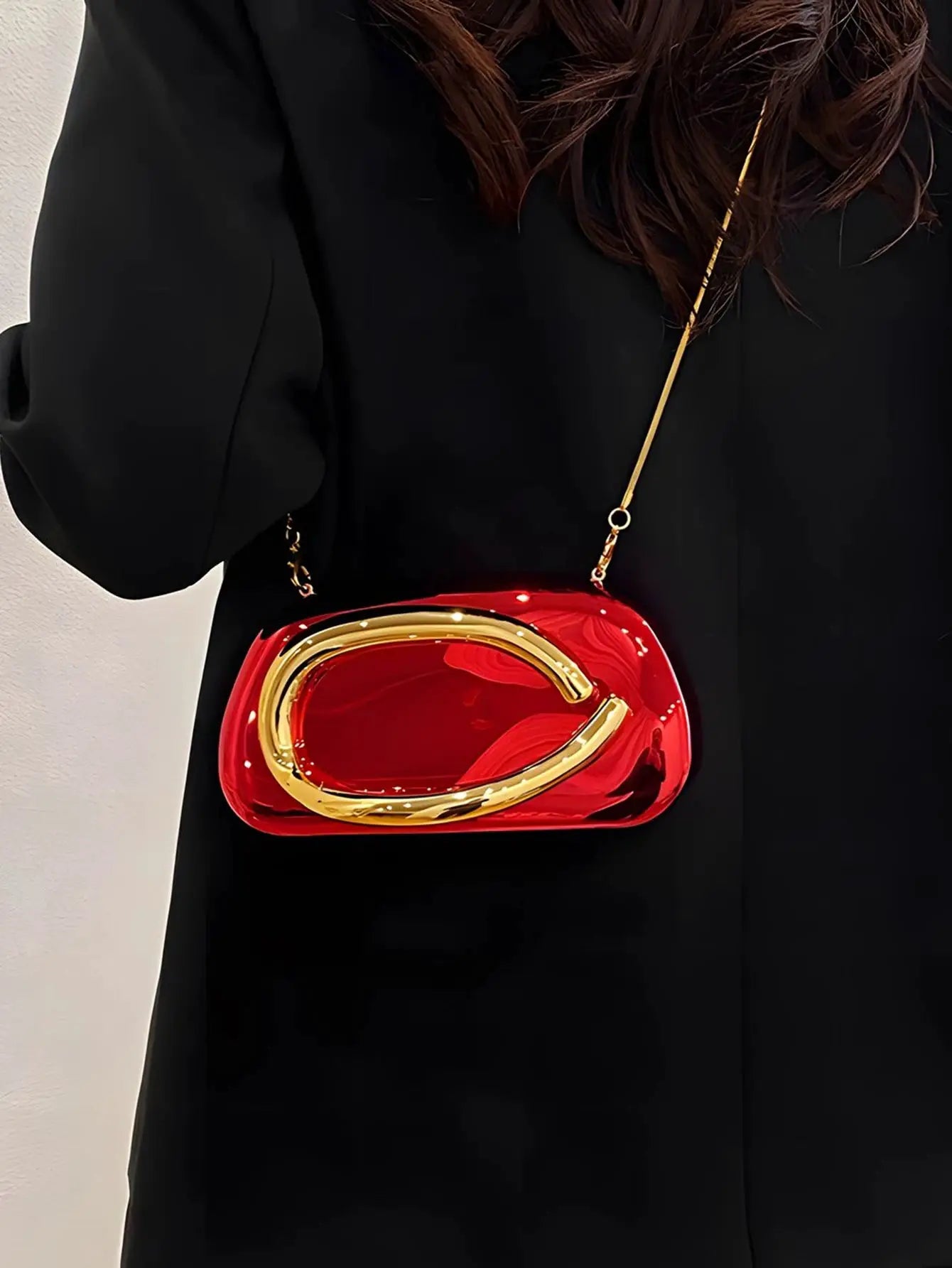 Red acrylic box crossbody bag with gold-tone frame and chain strap