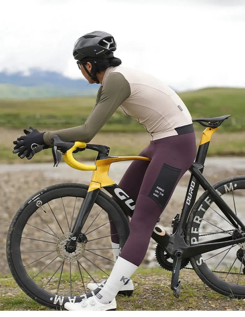 INBIKE men's winter cycling set: long-sleeve jersey and burgundy bib pants, olive sleeves on a yellow road bike