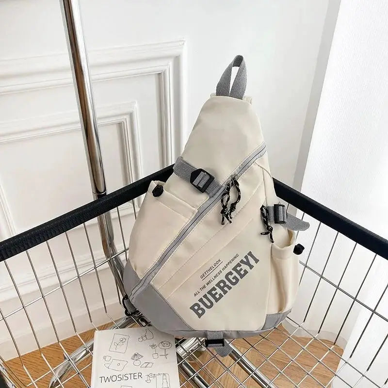 Beige nylon crossbody bag with gray trim, diagonal zip pocket, and side pockets
