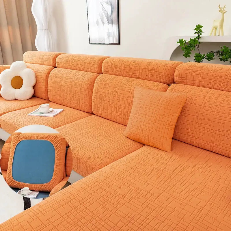 Orange string-plush sofa cover with matching cushions on a sectional sofa; elastic and removable.
