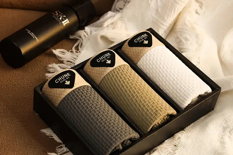 Three pairs of men's boxer shorts in gray, tan, and white with textured ice-silk fabric and CHUNE branding