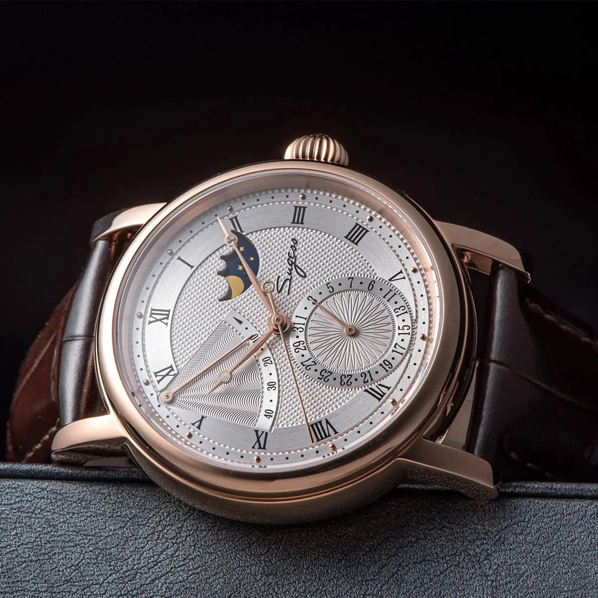 Sugess Moonphase men's watch with rose-gold case and brown leather strap, featuring moonphase display and date subdial