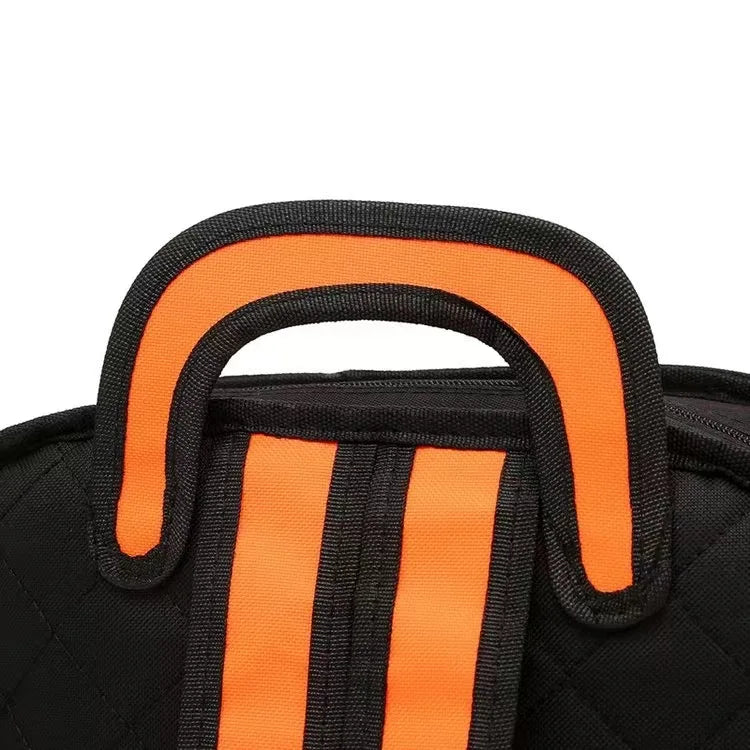 Backpack close-up of orange padded handle on black fabric.