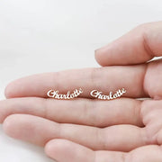 Charlotte name stud earrings in gold-tone stainless steel; pair