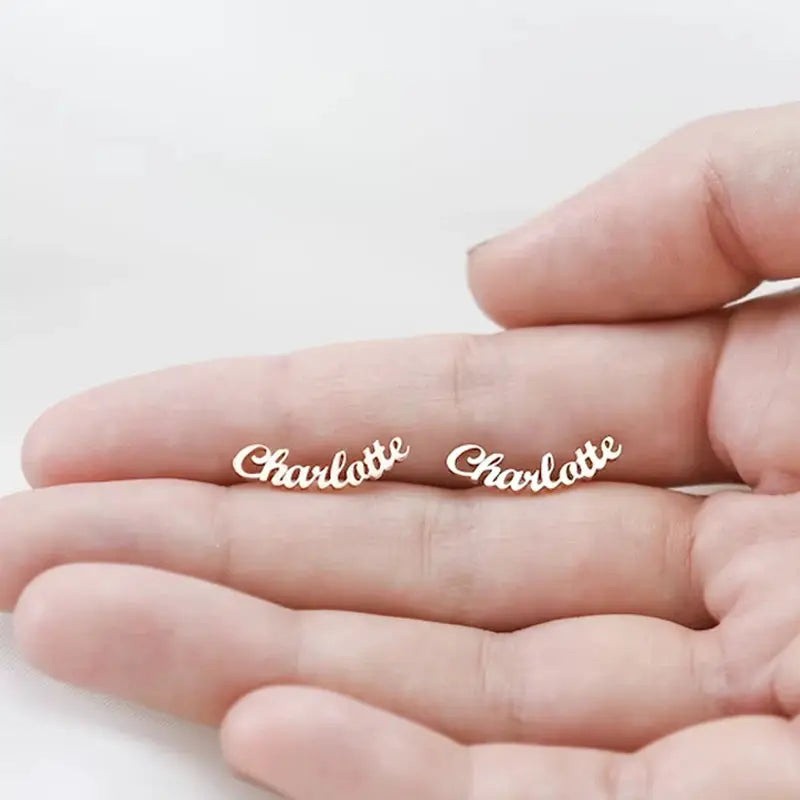 Charlotte name stud earrings in gold-tone stainless steel; pair