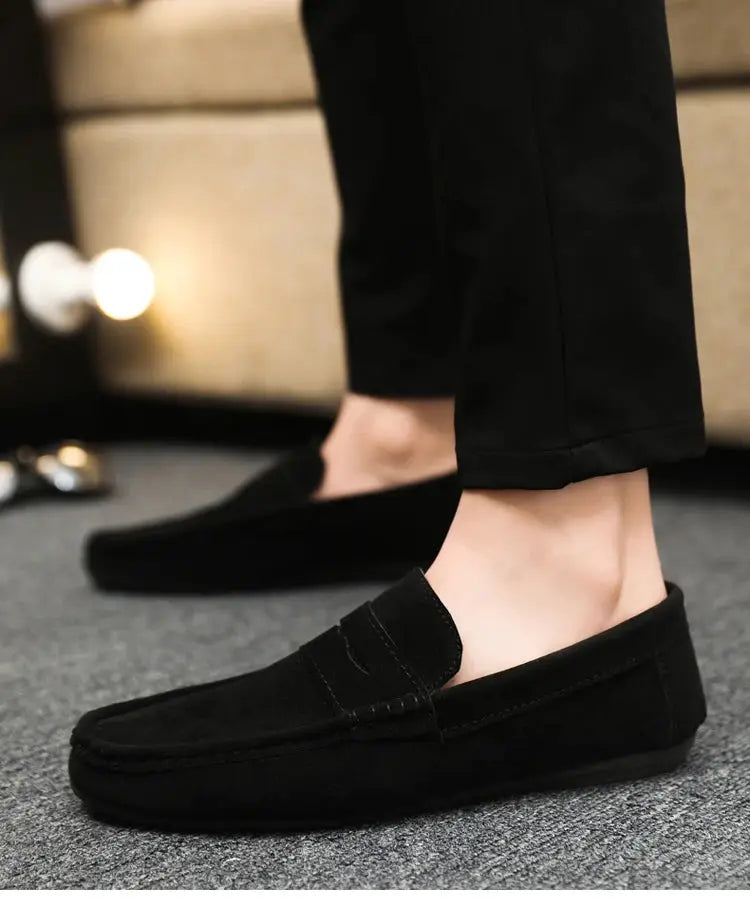 Pair of men's black suede driving loafers for casual and work wear