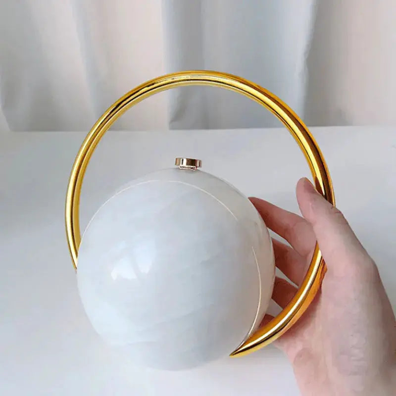 Acrylic ball clutch with a gold circular handle, white luxury evening handbag
