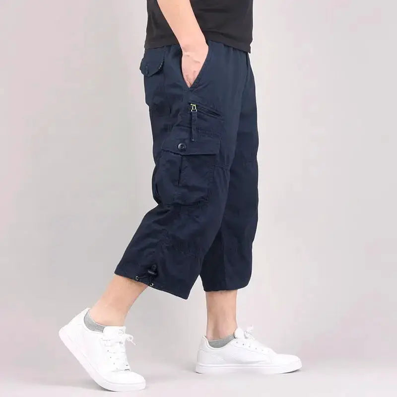 Men's navy cargo shorts with elastic waistband and multiple pockets; knee-length, loose-fit casual outdoor wear.
