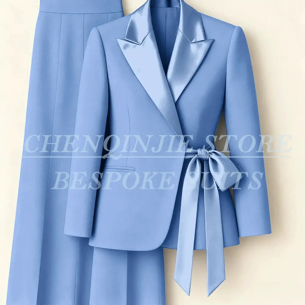 Light blue women's two-piece blazer and pants suit with peak lapel and waist-tie belt