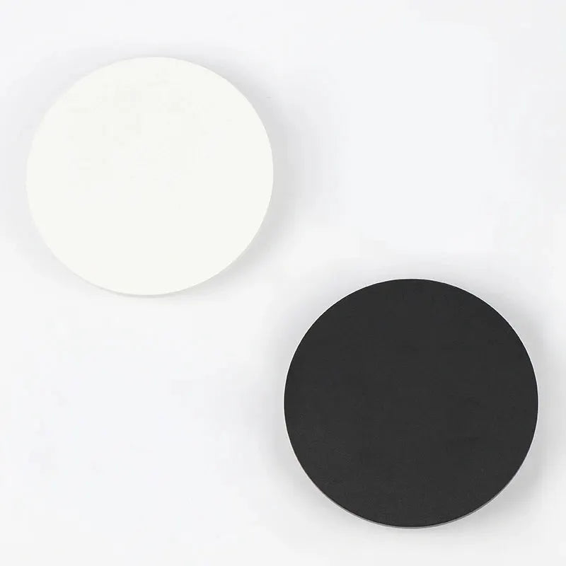 Indoor LED wall lamp by Simples Market; pair of round aluminum wall lights in white and black.