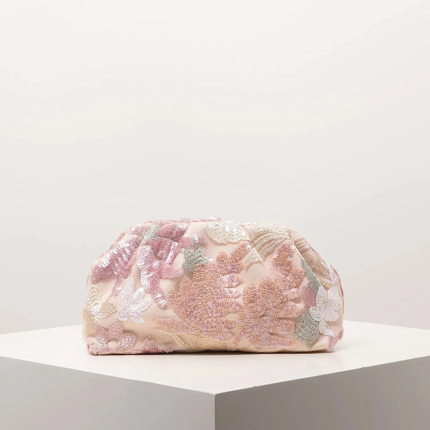 Clutch bag with blush pink fabric and pink floral sequin embroidery.
