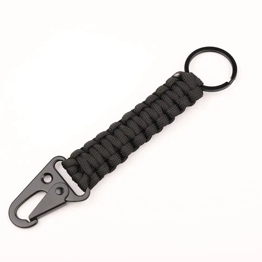 Paracord keychain with black braided rope, metal carabiner bottle opener, and ring for outdoor use.