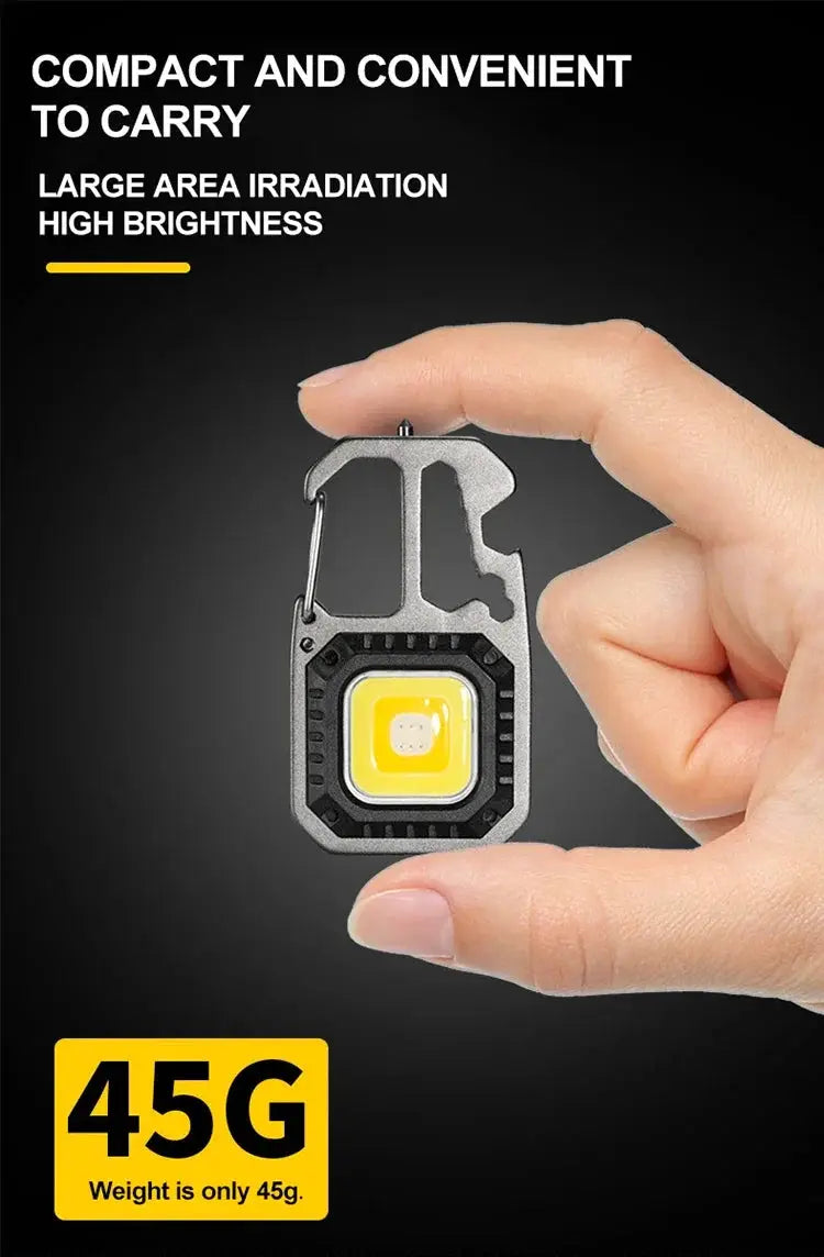 COB keychain work light with gray metal body and yellow LED, handheld size; 45g weight badge