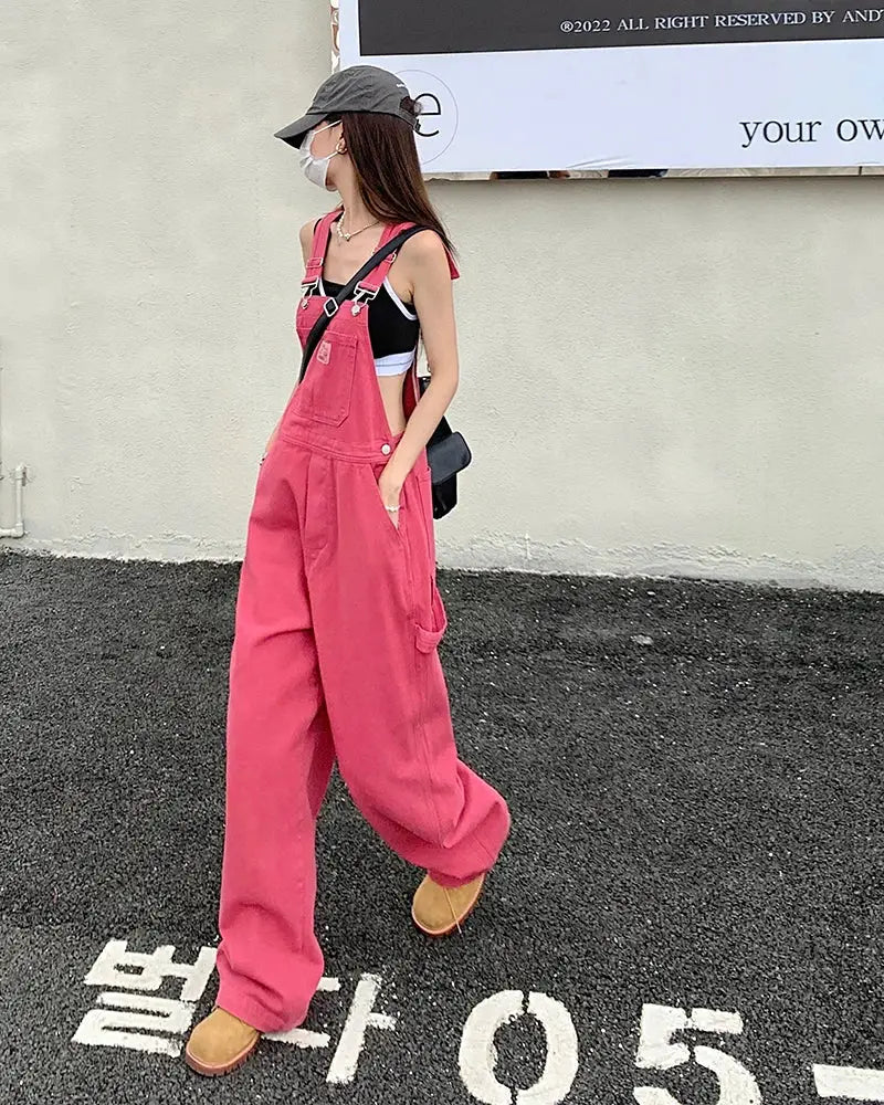 Pink denim overalls for women with a loose wide-leg fit