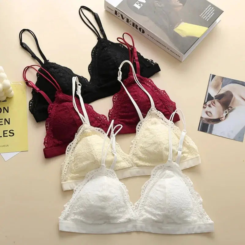 Set of four lace bralettes from Simples Market with double straps in black, burgundy, cream, white; scalloped edges.