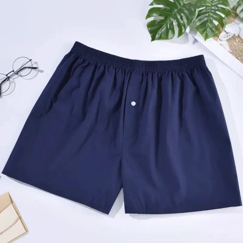 Men's navy cotton boxer shorts with elastic waistband.