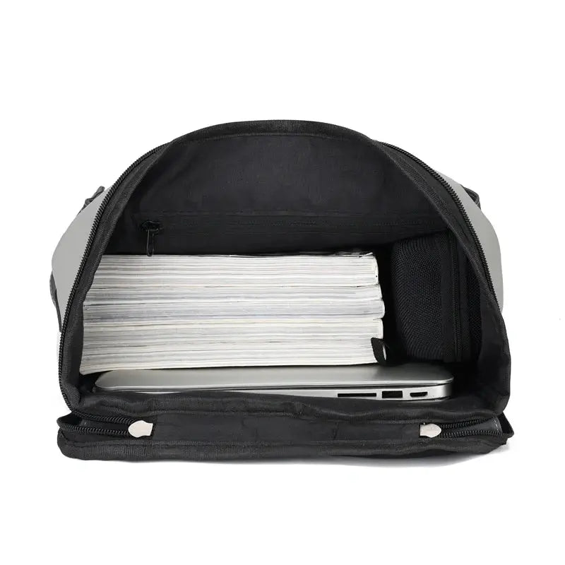 USB charging urban man backpack, gray exterior with black interior, opened to reveal a laptop and a stack of papers.