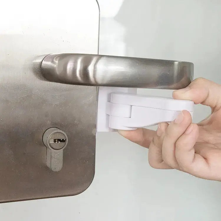 Universal door lever lock by Simples Market; white adhesive baby safety latch attached to metal door handle.