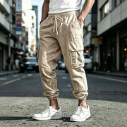 Simples Market men's beige cargo jogger pants with elastic waist, drawstring and multiple pockets; cotton-linen blend