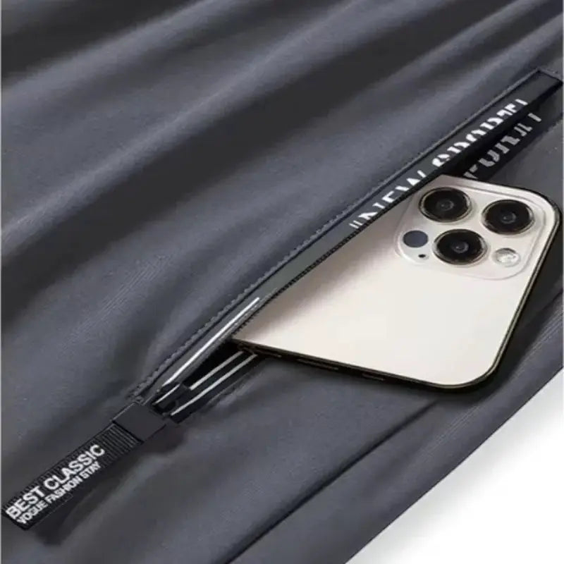 Men's fitness jogger pants with zippered pockets, dark gray stretch fabric; phone in pocket; BEST CLASSIC tag.