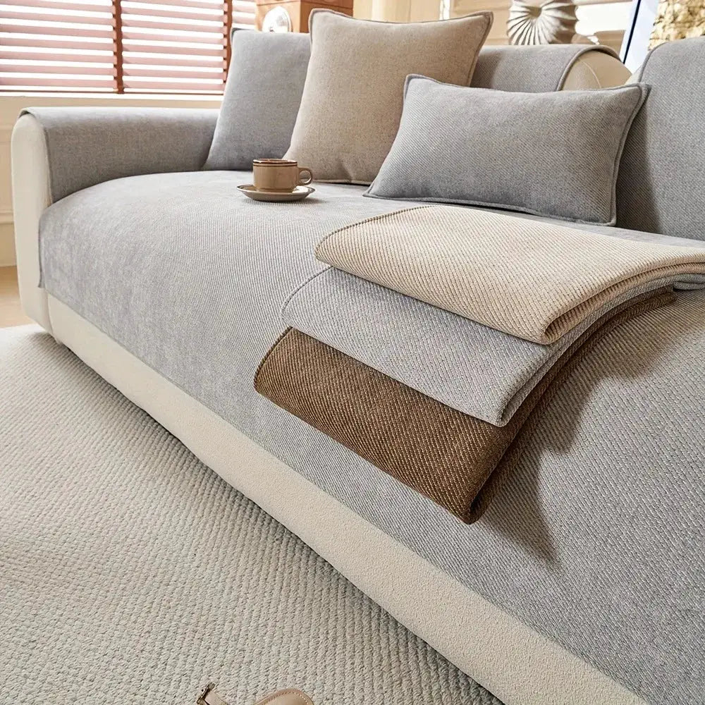 Minimalist Twill Chenille Anti-Slip Sofa Cover by Simples Market; light gray cover with three beige and brown throws.