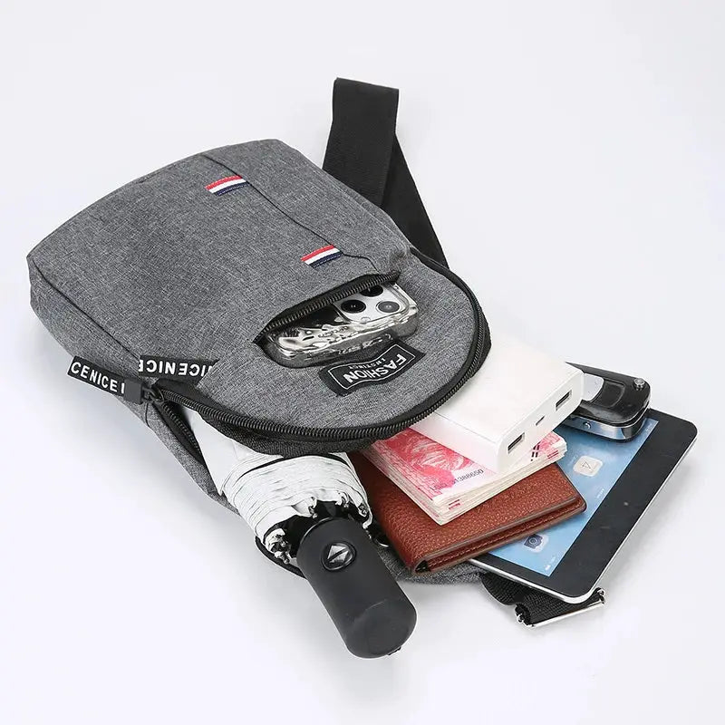 Grey chest bag with black strap; large-capacity crossbody shown with phone, tablet, wallet and cash.