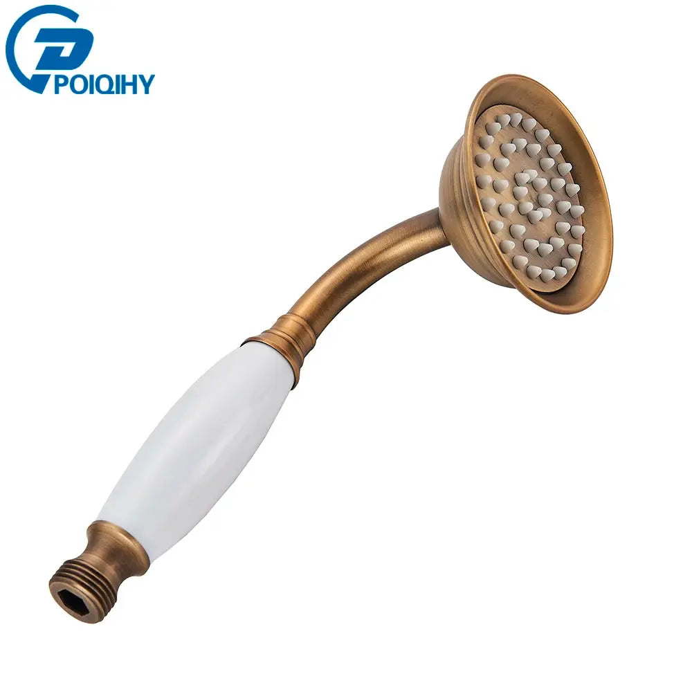 Antique brass handheld shower head with ceramic white handle and brass bracket.