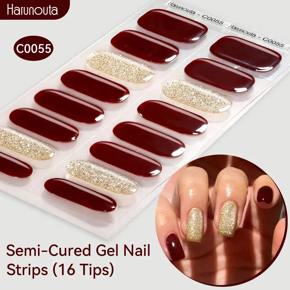 Gradient Auroras semi-cured gel nail strips by Haunouta, 16 burgundy and gold glitter tips