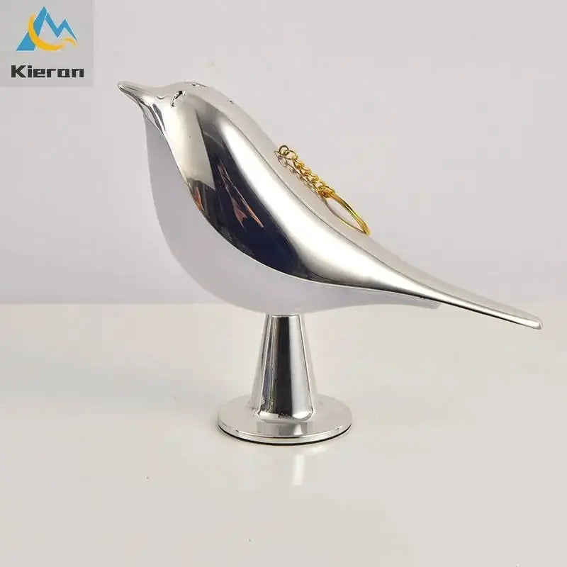 Kieron magpie LED desk lamp in chrome metal, bird-shaped with pedestal base and gold chain accent