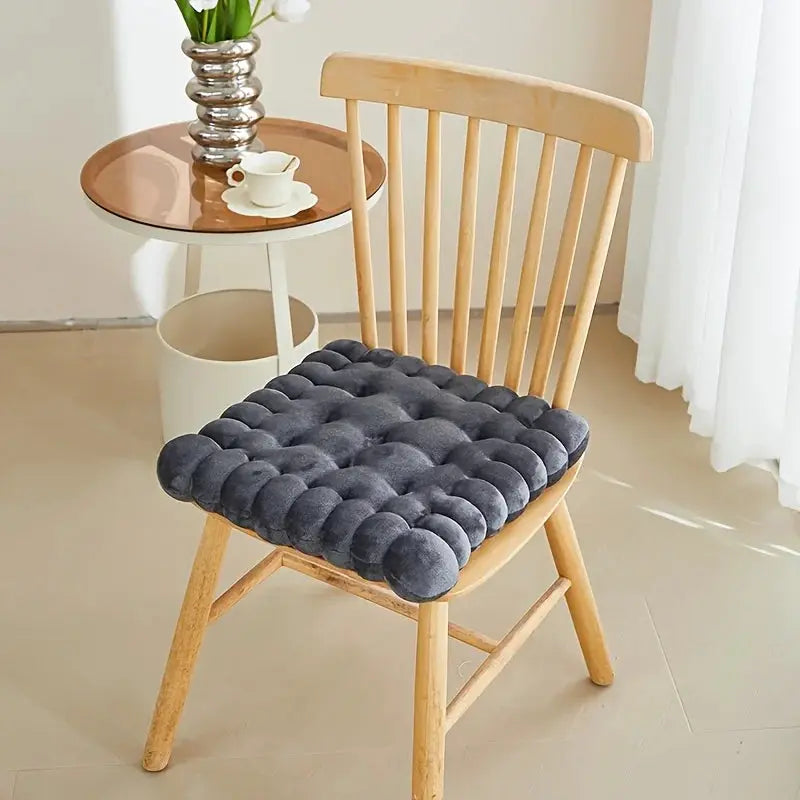 Large biscuit-shaped plush chair cushion in dark gray, tufted seat pad for wooden chair