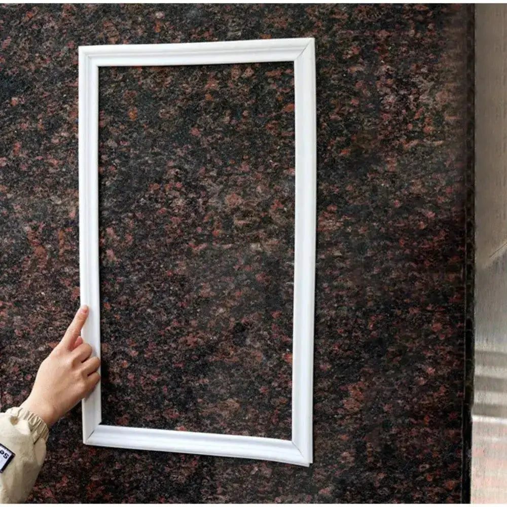 Self-adhesive PVC decorative strip, white and bendable, used as a frame border on a wall (1m roll)