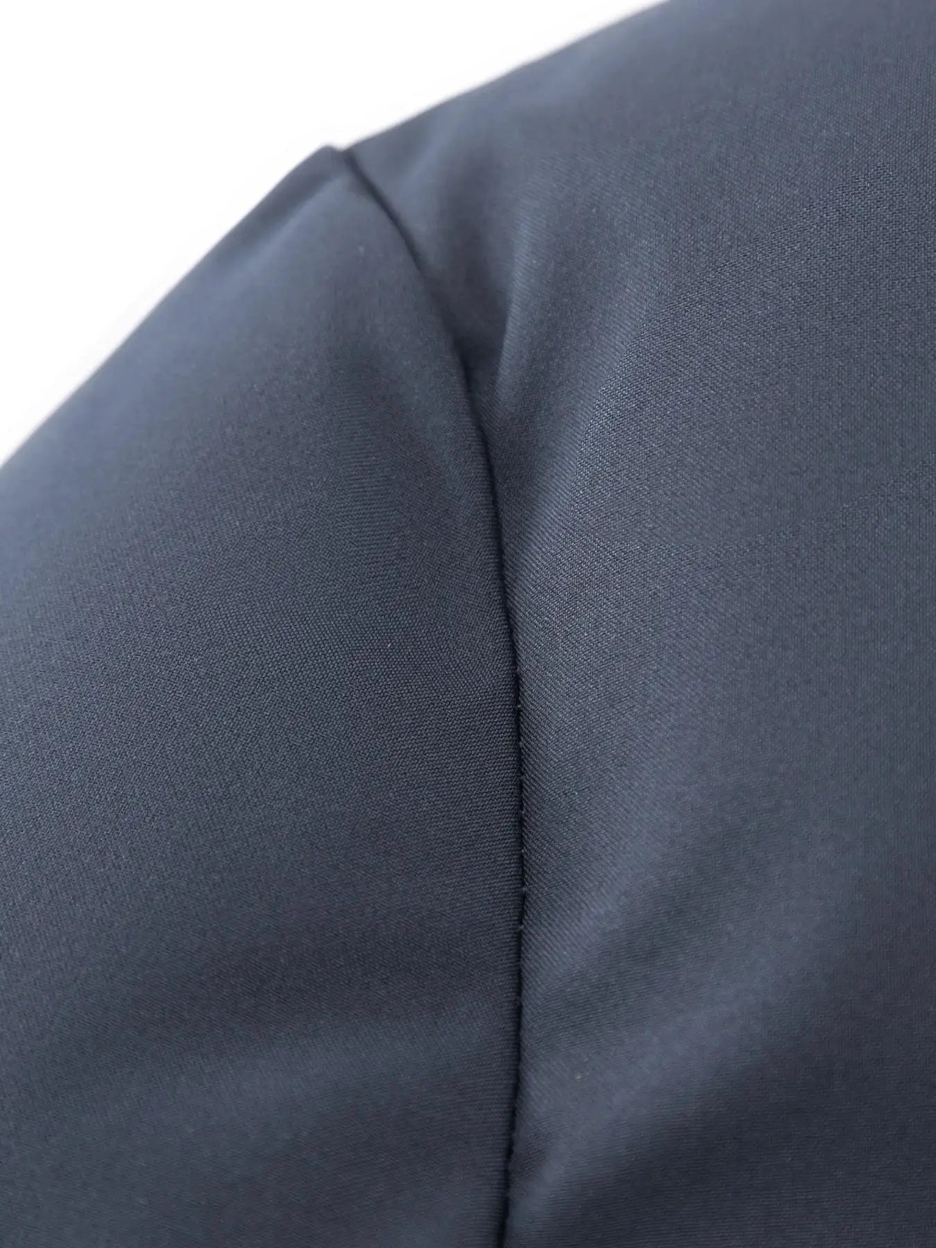 Men's navy cotton jacket fabric close-up showing seam detail