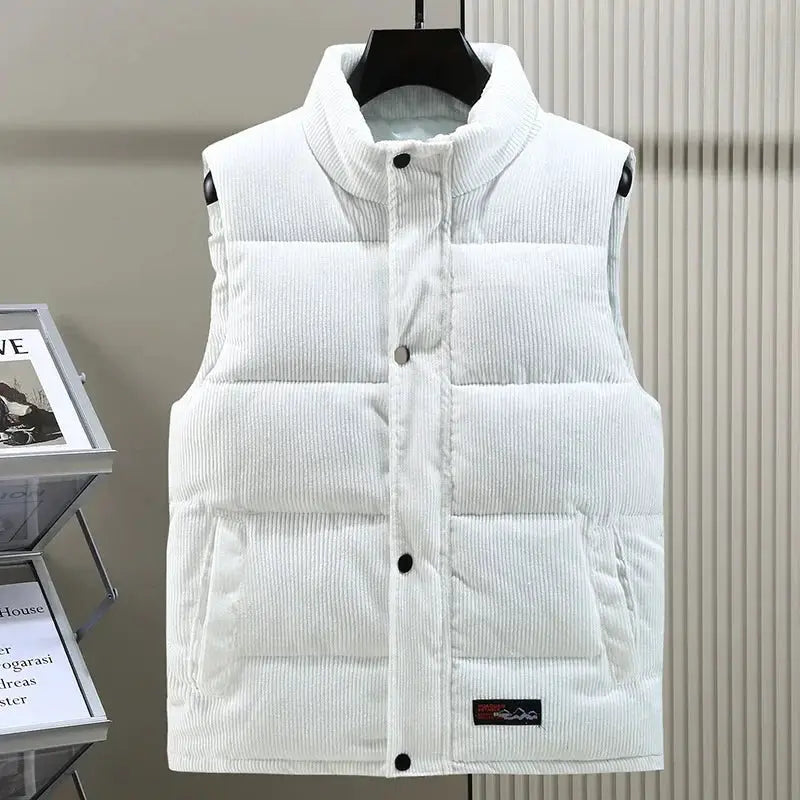 White padded corduroy sleeveless vest with stand collar, front snap buttons and side pockets.