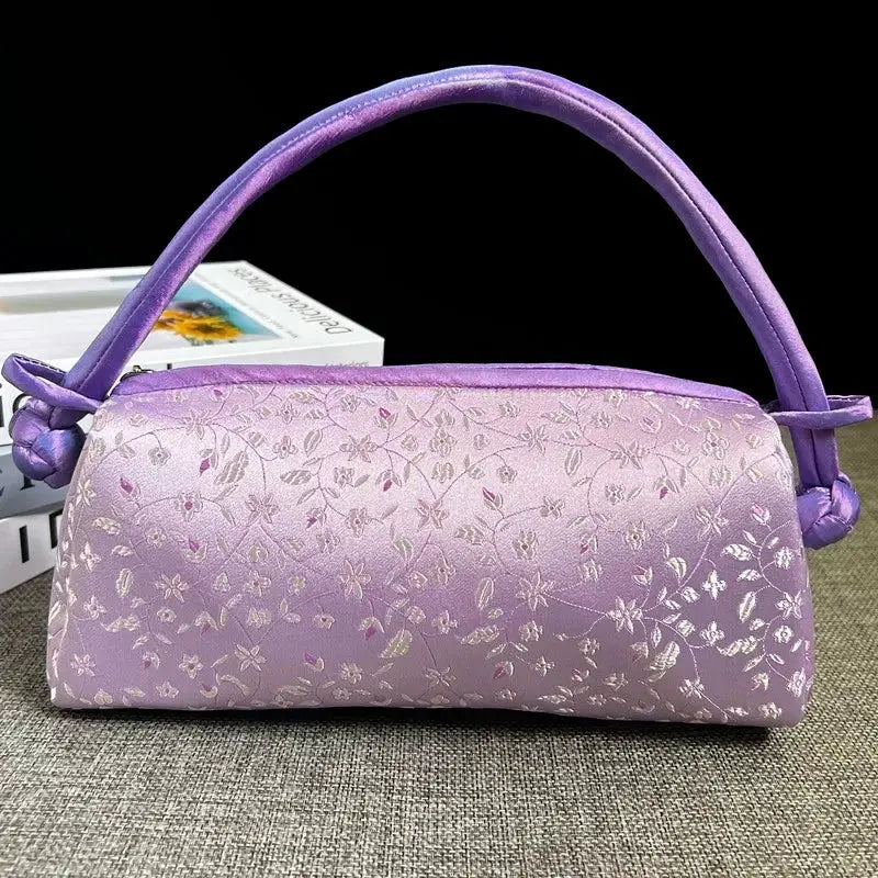 Satin shoulder bag in purple with embroidered floral pattern and knotted-end top handle