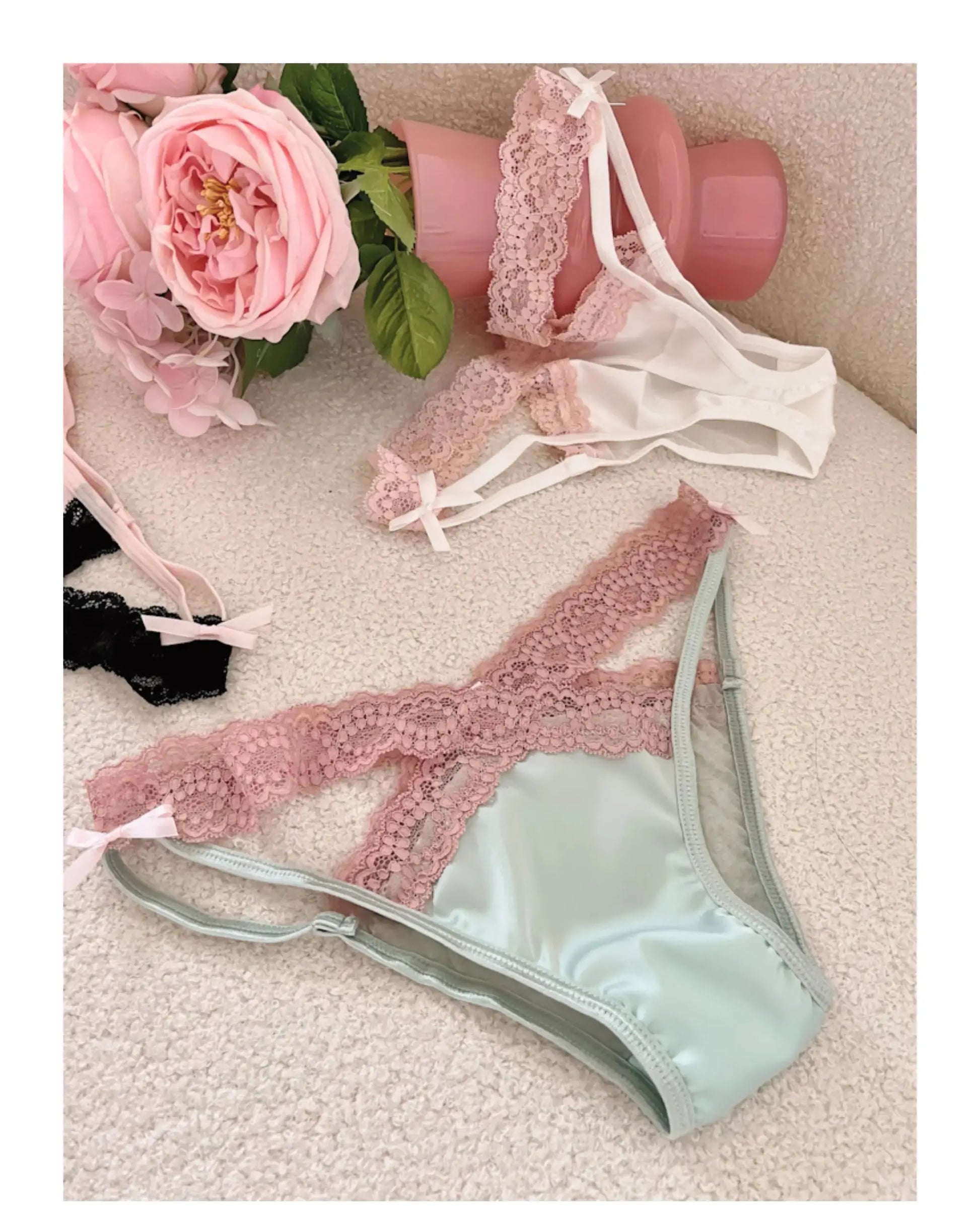 Pink lace lingerie set with bow accents, sheer mesh panels, and matching low‑waist panties
