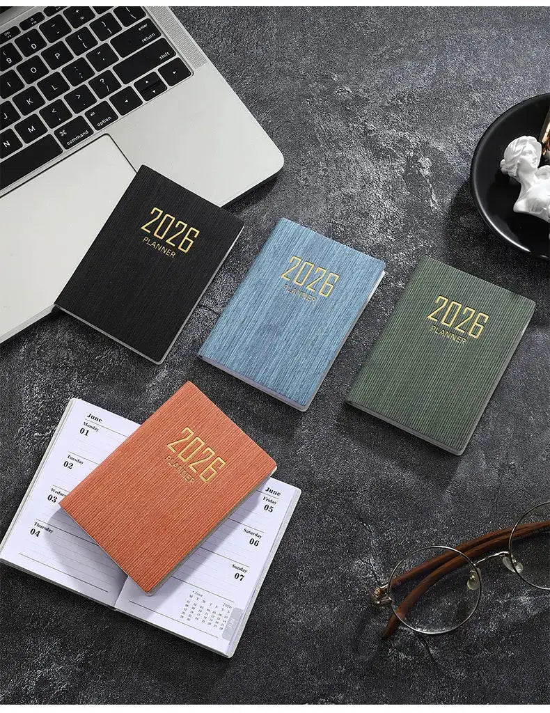 Simples Market A7 2026 English planner set; 4 pocket planners in black, blue, green, and orange with gold 2026 foil.