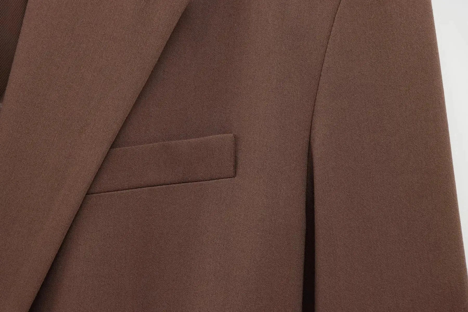 KONDALA brown blazer close-up showing textured fabric and pocket flap