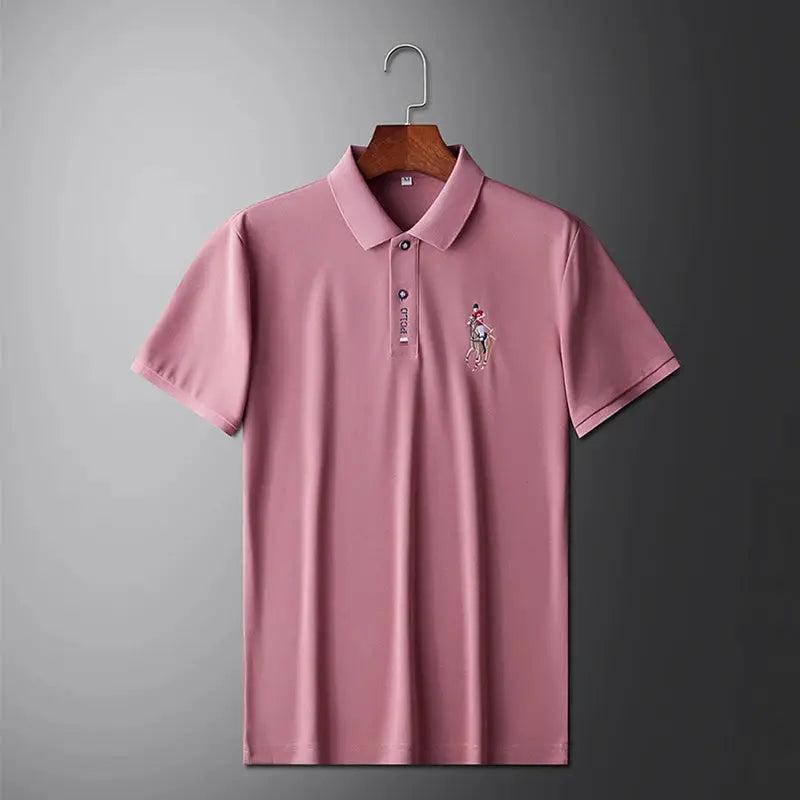 Men's pink polo shirt with short sleeves and embroidered chest design, displayed on a hanger