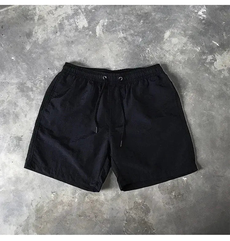 Simples Market black men's swim shorts with drawstring and elastic waistband.