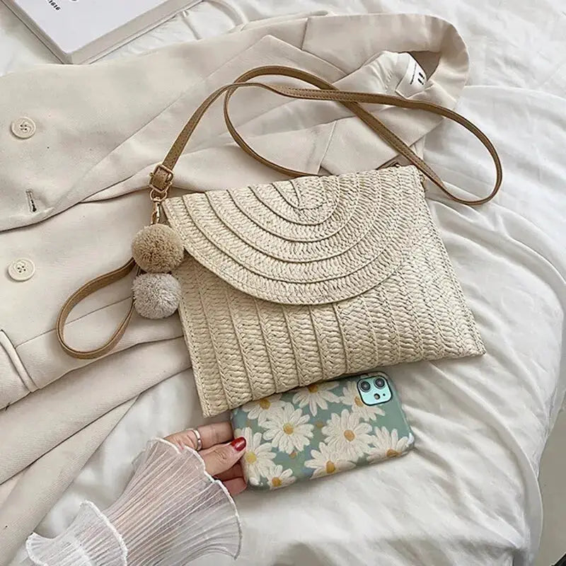 Handmade straw crossbody bag with envelope flap, beige woven texture, pom-pom charm, Simples Market