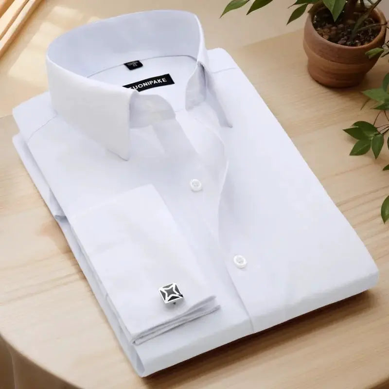 Men's white dress shirt by Simples Market, slim fit with French cuffs, folded on table; cufflink visible.