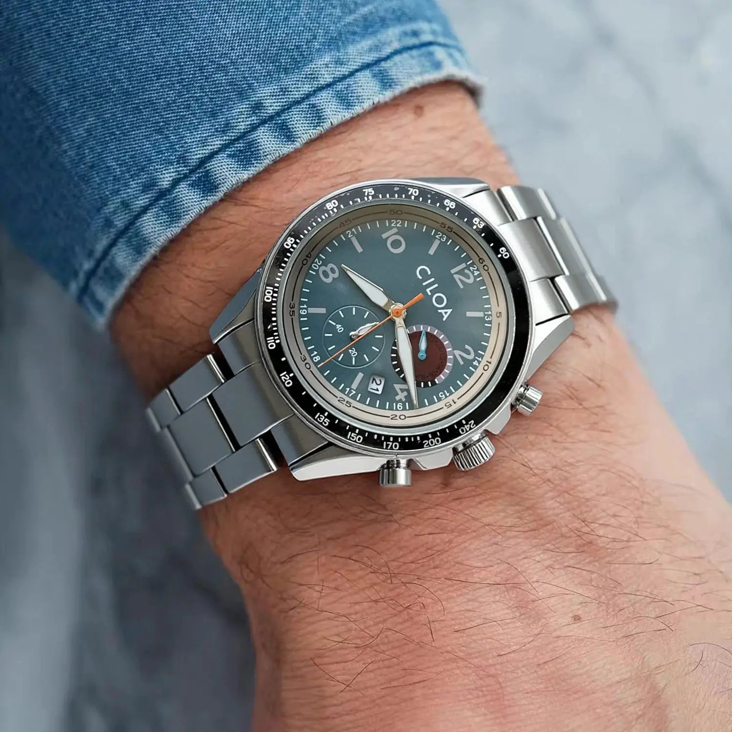 CILOA men's stainless steel chronograph watch on wrist; blue dial, black bezel, metal bracelet, waterproof quartz.